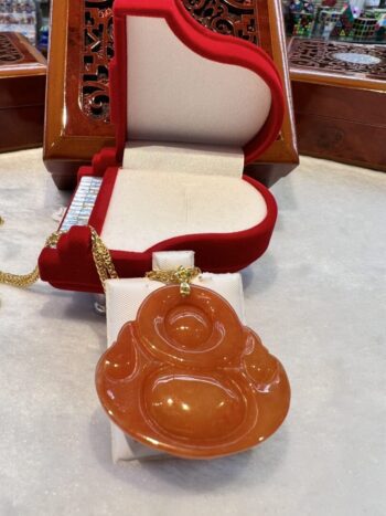 A red and white table with a necklace, ring box and bowl.