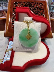 A green jade necklace is sitting on display.