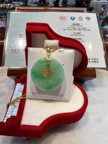 A green jade pendant in a red box.