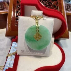 A green jade necklace is sitting on display.