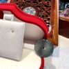 A close up of a red and white purse