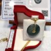 A green jade pendant in a red box.