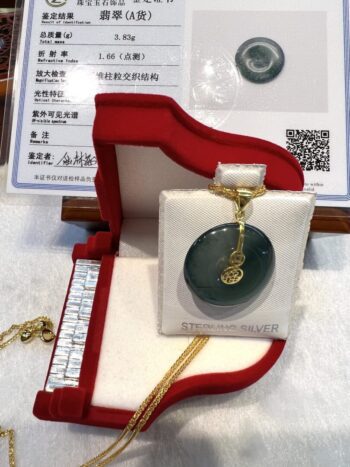 A green jade pendant in a red box.