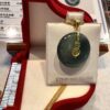 A green stone is sitting on top of a red box.