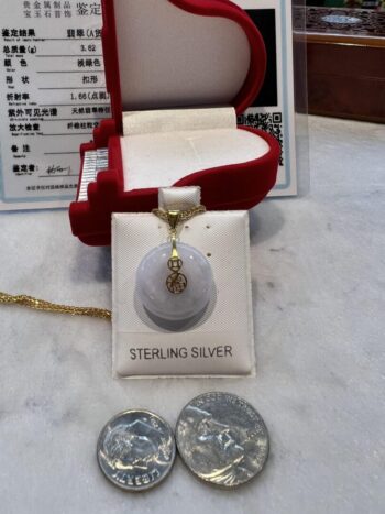 A silver necklace sitting on top of a table.