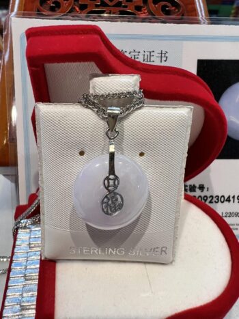 A white necklace with a silver chain and a pendant.