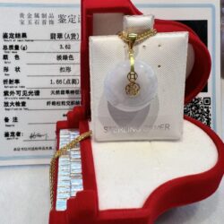 A white and gold necklace in a red box.