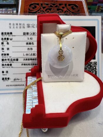 A white and gold necklace in a red box.