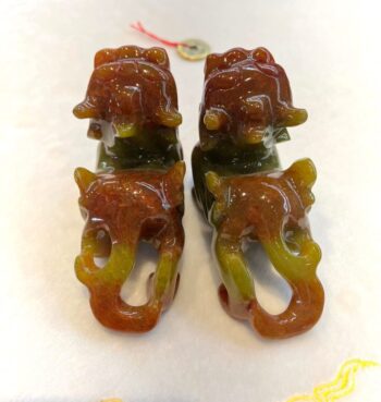 A pair of brown and green agate elephants.