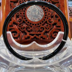 A black and white plastic headband sitting on top of a chair.