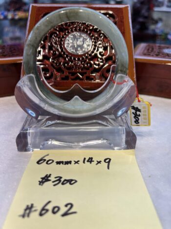 A glass clock sitting on top of a table.