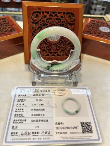 A green and white bracelet sitting on top of a table.