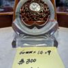 A glass clock sitting on top of a table.