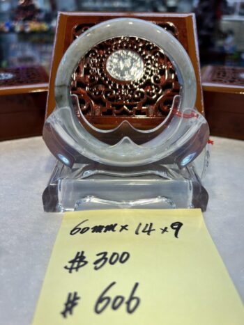 A glass clock sitting on top of a table.