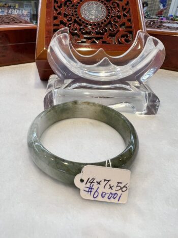 A green and white bracelet sitting on top of a table.