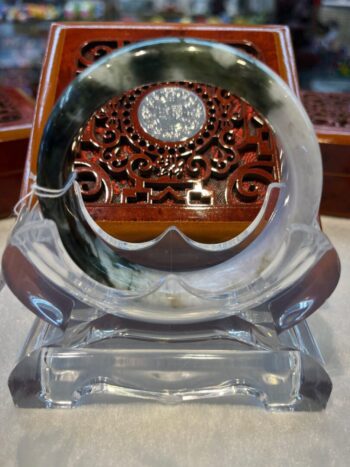 A glass clock sitting on top of a table.