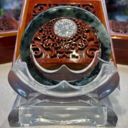 A wooden clock sitting on top of a glass table.