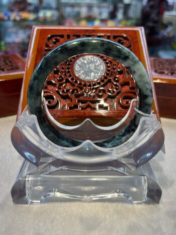 A wooden clock sitting on top of a glass table.