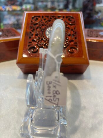 A small glass bottle sitting on top of a table.