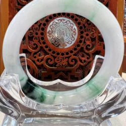 A green and white plate sitting on top of a glass table.