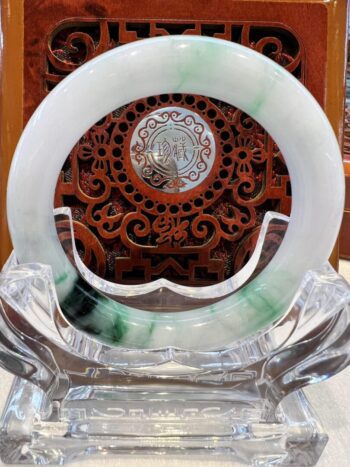 A green and white plate sitting on top of a glass table.