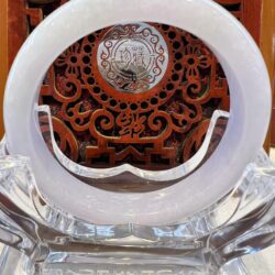 A white glass bowl sitting on top of a wooden table.