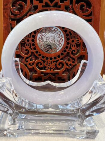 A white glass bowl sitting on top of a wooden table.