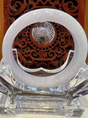 A white plate sitting on top of a glass table.