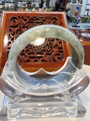 A large jade bangle sitting on top of a table.