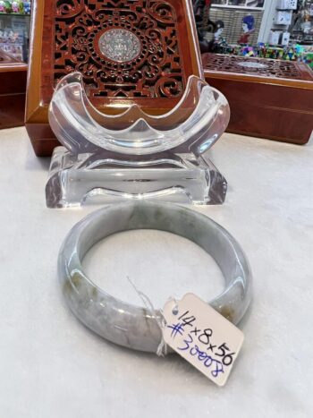 A gray bangle sitting on top of a table.