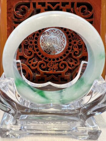 A white and green plate sitting on top of a glass table.