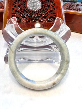 A white bangle sitting on top of a table.