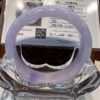 A purple bracelet sitting on top of a glass table.