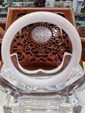 A white plastic object sitting on top of a wooden chair.