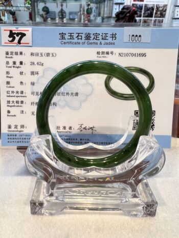 A green jade bangle sitting on top of a table.