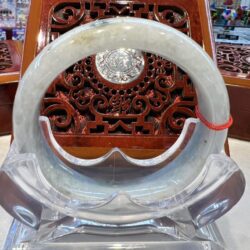 A large white stone ring sitting on top of a chair.