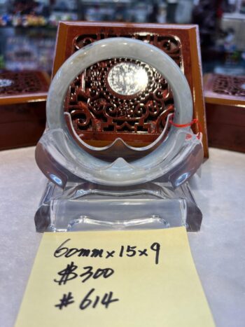 A glass clock sitting on top of a table.