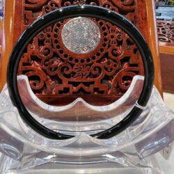 A black and silver circular object sitting on top of a table.