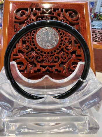 A black and silver circular object sitting on top of a table.