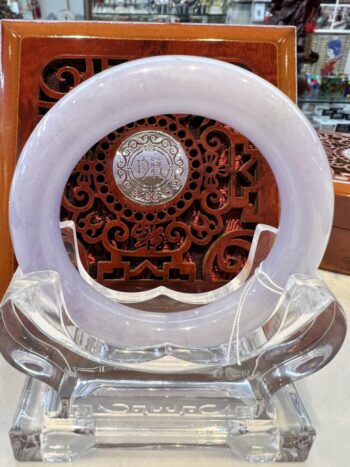 A white glass plate sitting on top of a clear plastic holder.