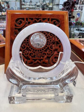 A clear glass sculpture with a clock on it.