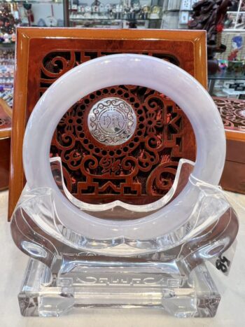 A white clock sitting on top of a glass table.