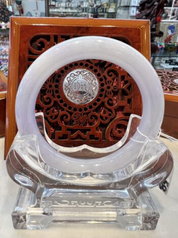 A white clock sitting on top of a glass table.