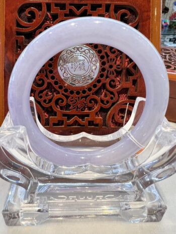 A white plate sitting on top of a clear glass table.