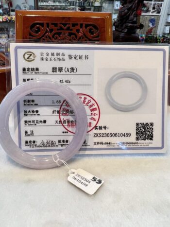 A plastic ring sitting on top of a certificate.