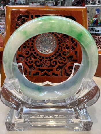 A green and white bangle sitting on top of a table.