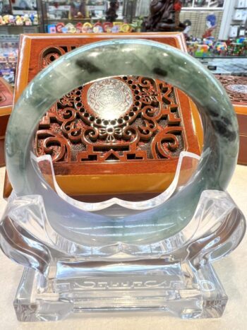 A close up of a glass ring on top of a wooden table.