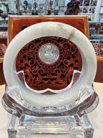 A white plate with a carved wooden design.