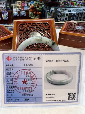 A certificate of authenticity for an antique chinese ring.