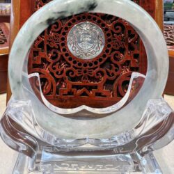 A round marble plate with a carved design on it.